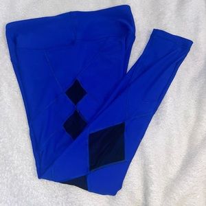 Blue design leggings. Black mesh diamond shaped cut outs in the sides.